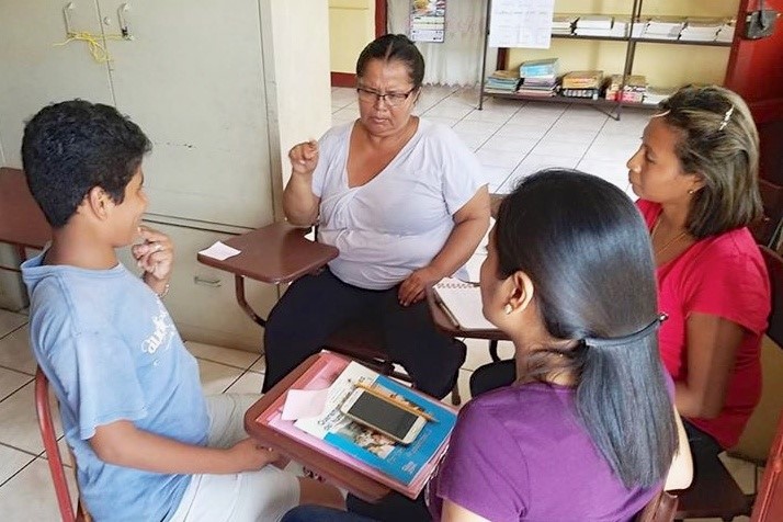 Yadir, one of the Deaf students at the school, is teaching mothers to use Nicaraguan Sign Language for conversations with their families.